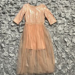 Beautiful formal dress for girls. Peach iridescent sequins with 3/4 sleeves.